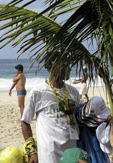 Buying clothes in Rio, hat salesman